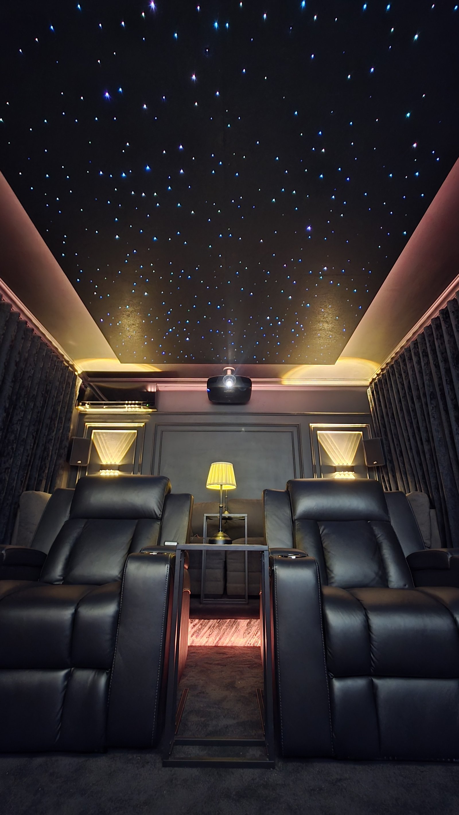 A Starz Designs fibre-optic star ceiling glowing above a private cinema